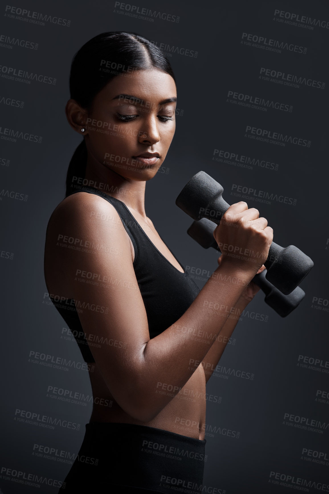 Buy stock photo Sports, serious and woman with dumbbell for workout in studio isolated on a black background. Strong, bodybuilder and Indian female athlete weightlifting for muscle, training and fitness exercise.