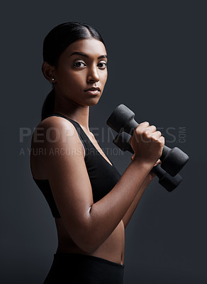 Buy stock photo Serious, portrait and woman with dumbbells for workout in studio isolated on a black background. Strong, bodybuilder and Indian female athlete weightlifting for muscle, training and fitness exercise.