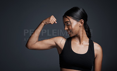 Buy stock photo Sports, smile and woman flexing bicep in studio isolated on black background. Strong, happy and Indian female athlete with muscle, arm strength and bodybuilder ready for fitness, workout or exercise.