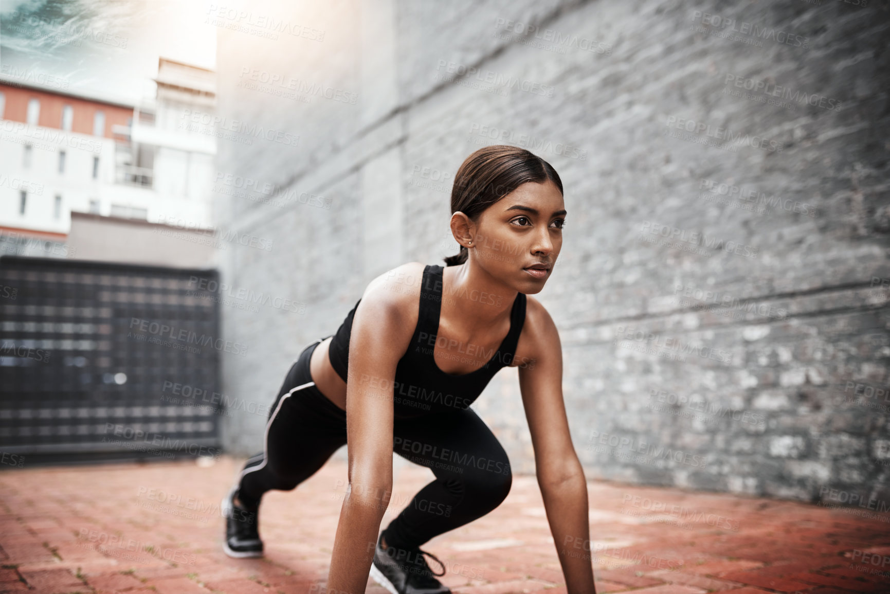 Buy stock photo Indian woman, fitness and start position outdoor for race, stretching and exercise in city. Female runner, wellness and training in urban area for athlete, competition and cardio for sports or health