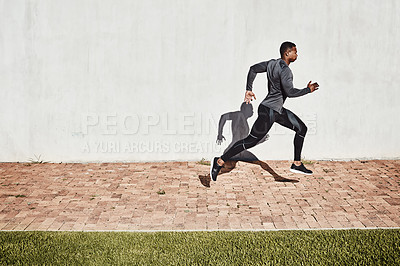 Buy stock photo Full length shot of a handsome and athletic young man running on a path through the park