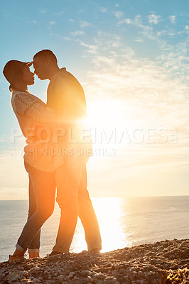 Buy stock photo Shot of a happy young couple sharing a romantic moment outdoors