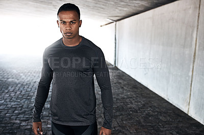 Buy stock photo Cropped portrait of a handsome and athletic young man standing outside while running in the city