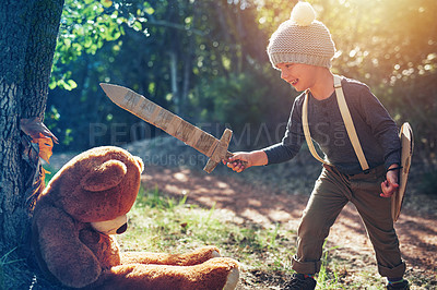Buy stock photo Shot of an adorable little boy playing with a cardboard sword and shield outside