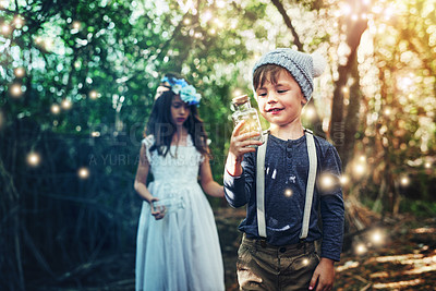 Buy stock photo Shot of two little siblings catching fireflies in jars outside
