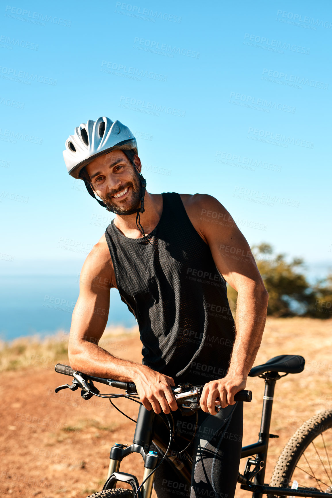 Buy stock photo Cropped portrait of a handsome young male cyclist out for a ride on his mountain bike