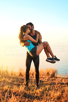 Buy stock photo Full length shot of an affectionate couple kissing while out for a workout