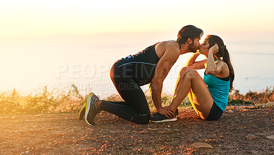 Buy stock photo Full length shot of a handsome young man kissing his girlfriend while she does sit ups
