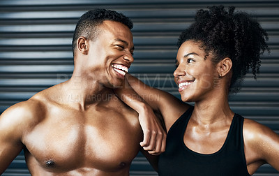 Buy stock photo Shot of a sporty young couple standing together against a grey background