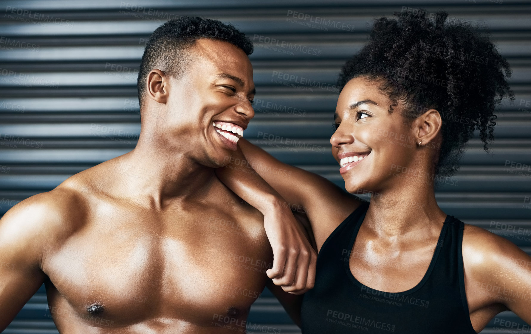 Buy stock photo Shot of a sporty young couple standing together against a grey background