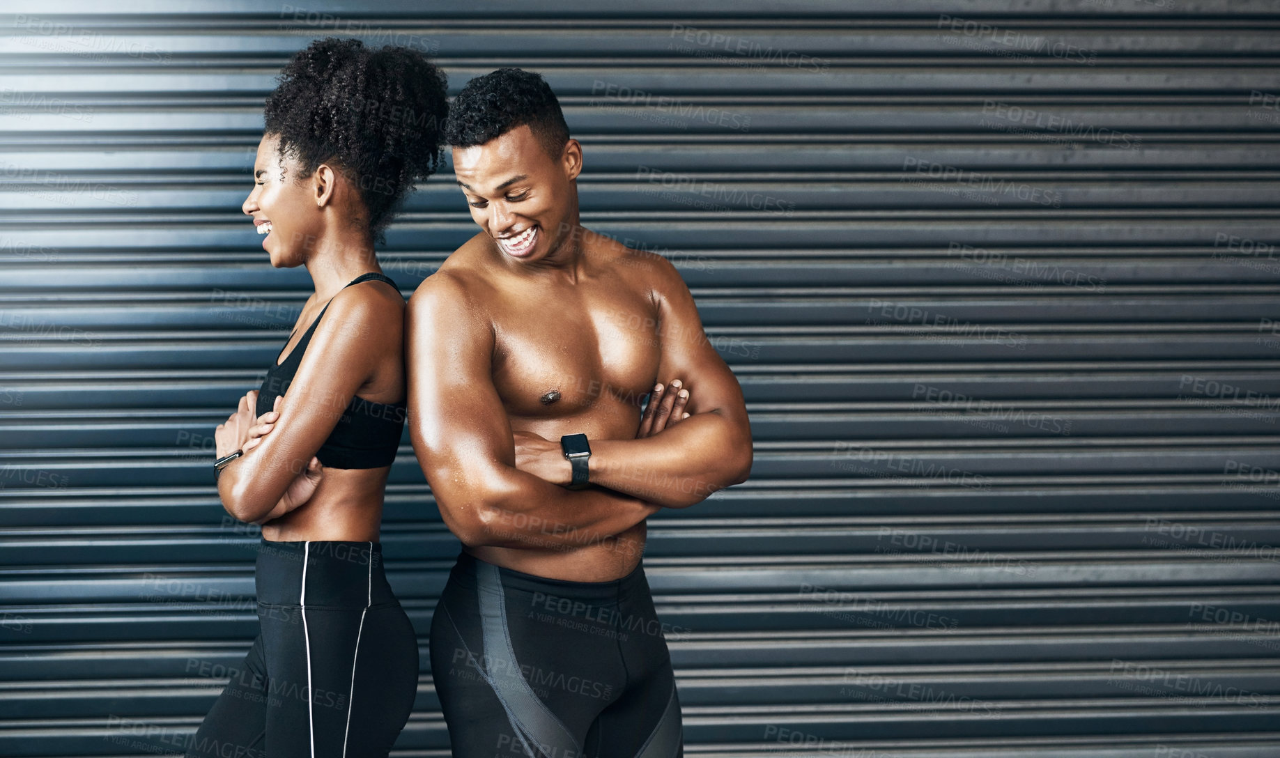 Buy stock photo Shot of a sporty young couple standing together against a grey background