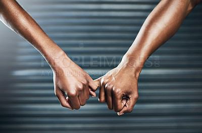 Buy stock photo Closeup shot of a sporty couple holding each other's little finger against a grey background