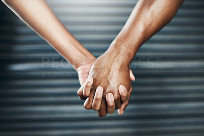 Buy stock photo Closeup shot of a sporty couple holding hands against a grey background