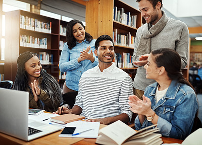 Buy stock photo Cropped shot of a group of university students studying in the library