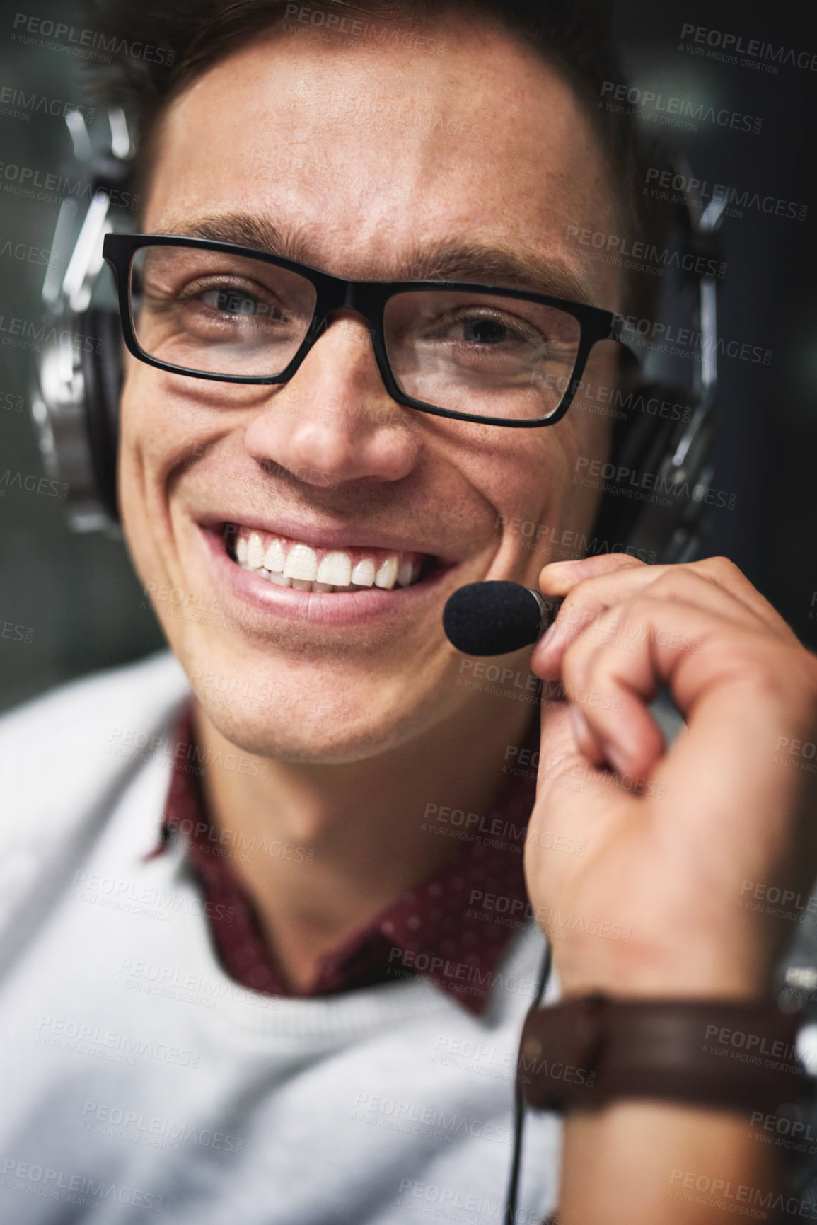 Buy stock photo Cropped portrait of a handsome young businessman working late in a call center