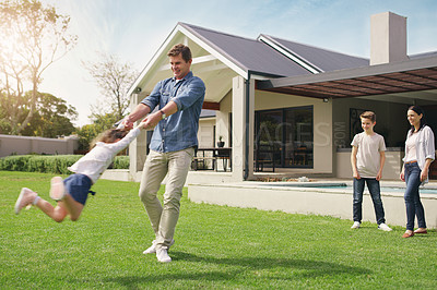 Buy stock photo Happy family, real estate and playing on grass together from holiday, weekend or break in the outdoors. Father swinging child on new home, lawn or property for fun time or play outside the house