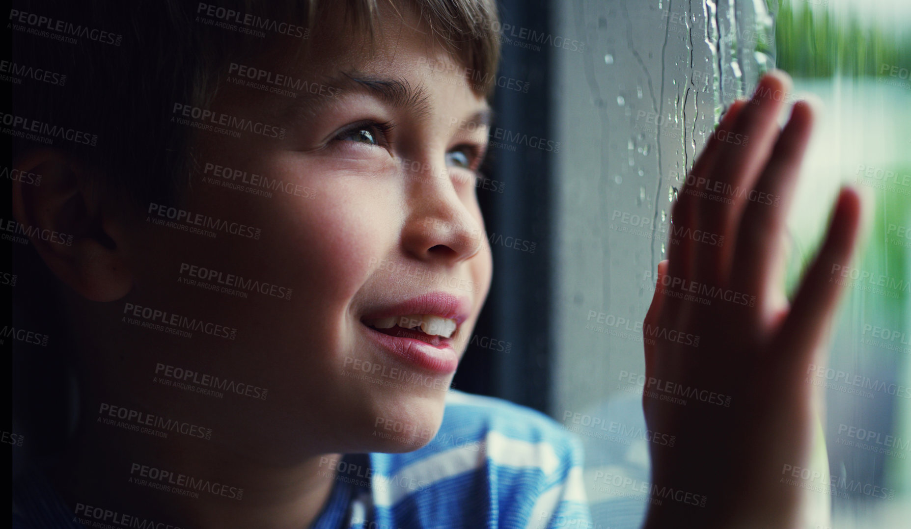 Buy stock photo Child, window and smile at rain drops or thinking in home with cold weather, thoughts or future. Male person, boy and hand or contemplating in winter for decision or wondering, youth or daydreaming