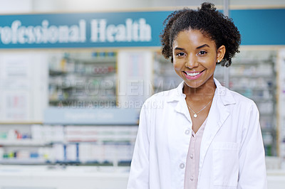 Buy stock photo Portrait of an attractive young pharmacist smiling and posing in a pharmacy