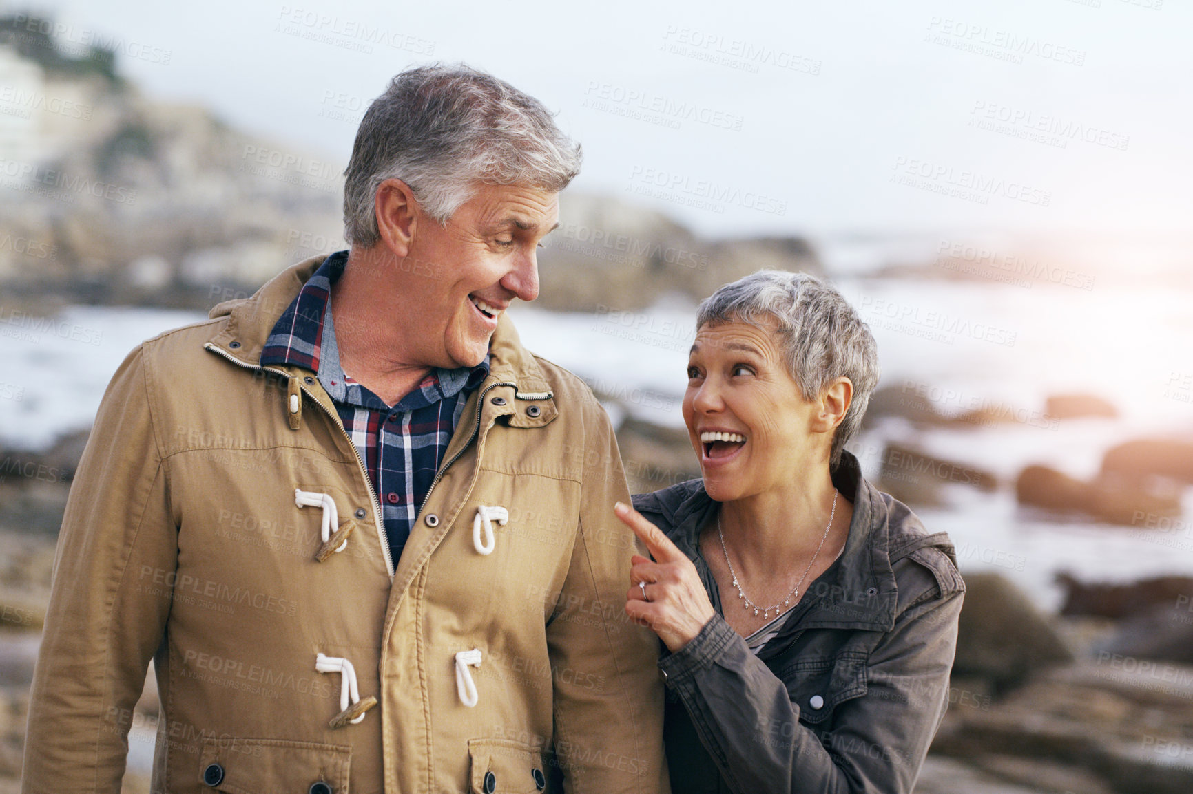 Buy stock photo Shot of a beautiful elderly couple taking a walk at the beach