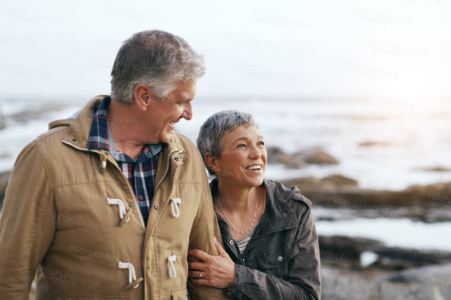 Buy stock photo Senior couple, relax and beach walk outdoor with smile from marriage and love. Happy, elderly people and mockup by a ocean and sea on holiday with travel and walking on vacation with retirement