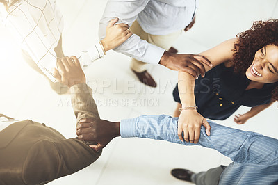 Buy stock photo Closeup shot of a group of businesspeople linking their arms in solidarity