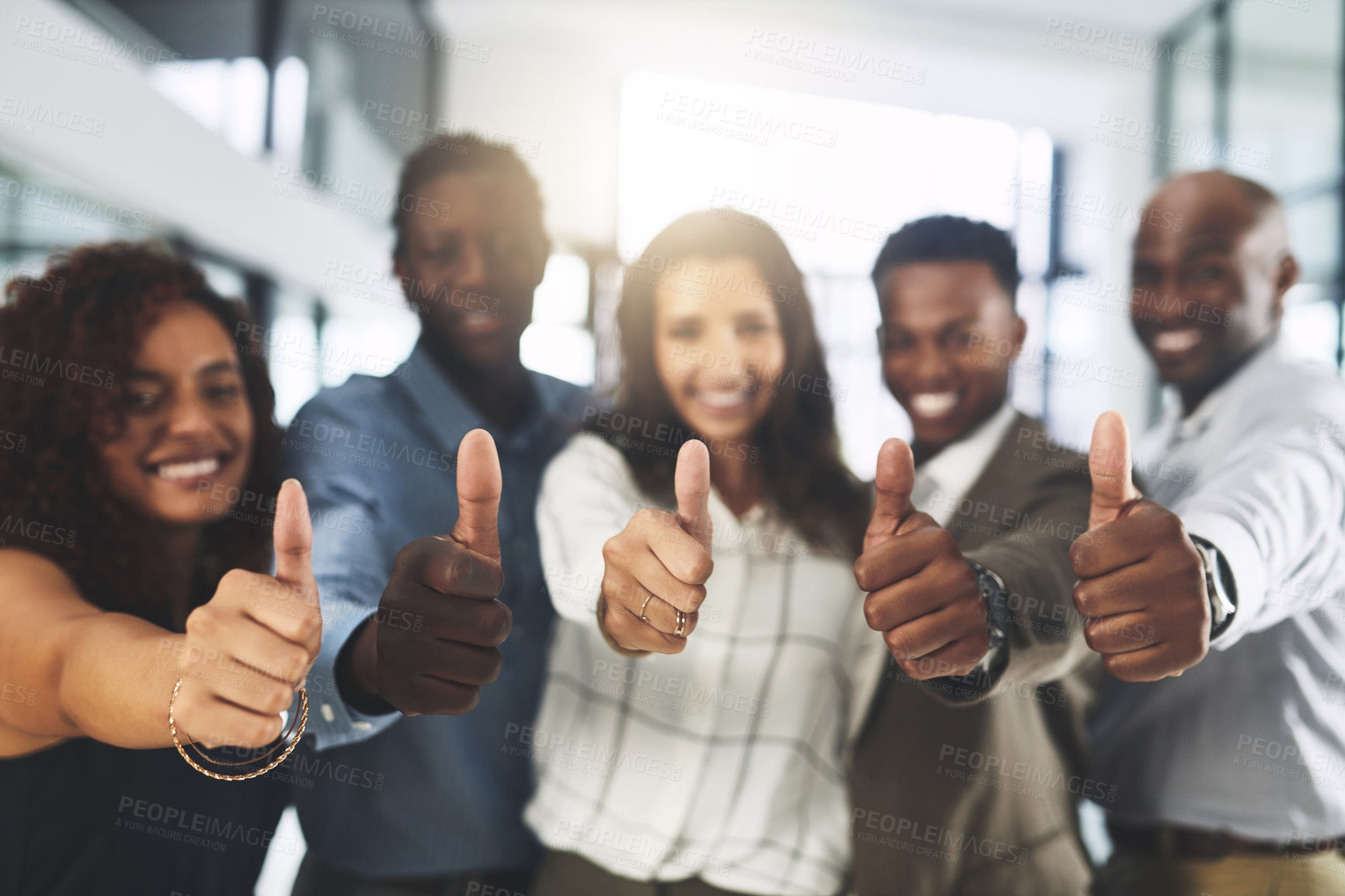 Buy stock photo Portrait of a group of businesspeople showing thumbs up in an office