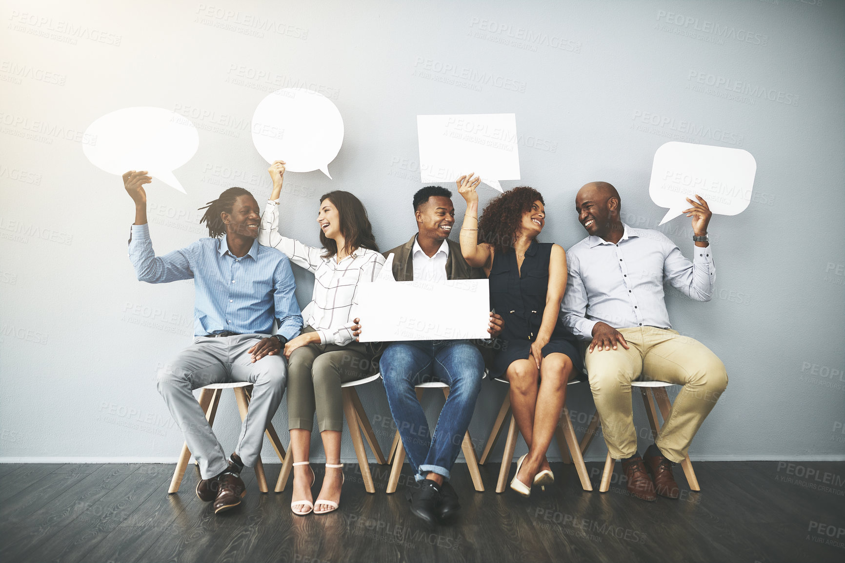 Buy stock photo Studio shot of a group of businesspeople holding speech bubbles in line against a gray background