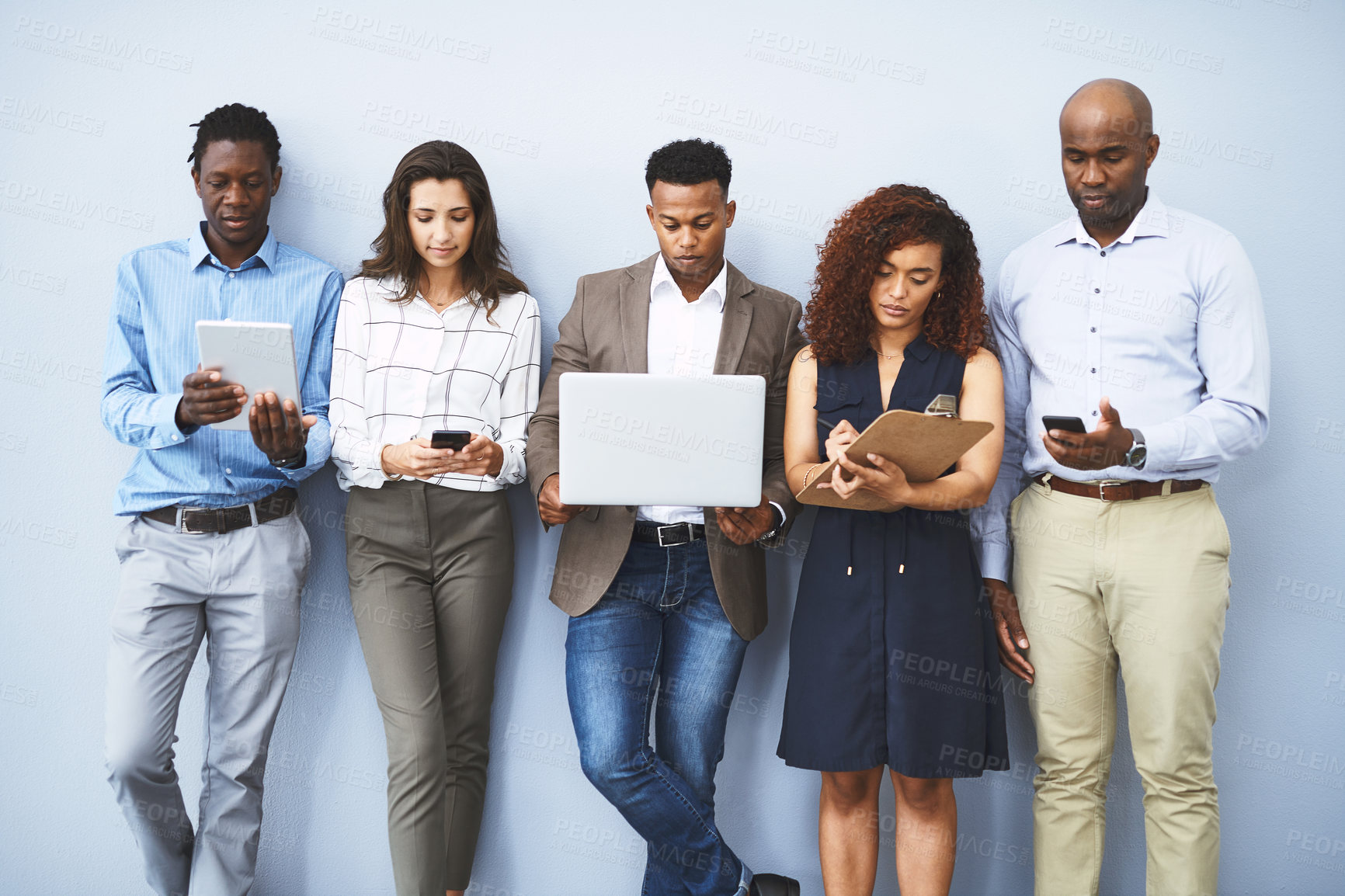 Buy stock photo Laptop, tablet and row of business people in office for job interview, hiring and networking. Diversity, company and men and women on technology for queue, recruitment and contact on wall background