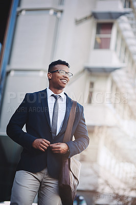 Buy stock photo Shot of a handsome young businessman in the city