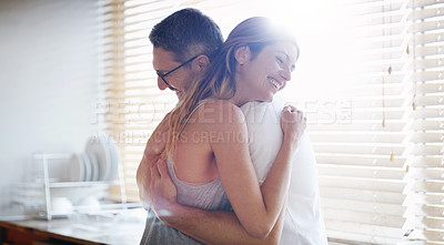 Buy stock photo Kitchen, hug and happy couple in house with love, support and bonding with lens flare. Marriage, morning and people embrace at home with security, safety and protection, gratitude and connection
