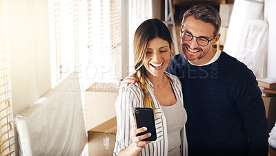 Buy stock photo Shot of a mature couple taking selfies in their new house