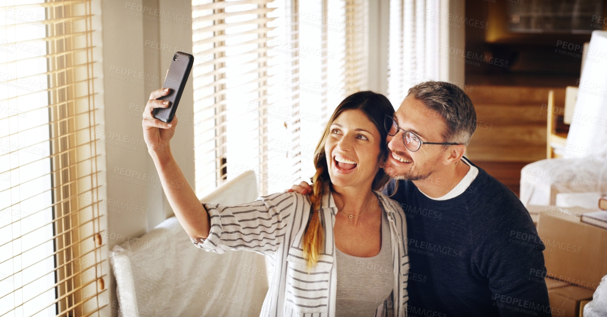 Buy stock photo Couple, moving and boxes with selfie, new house or excited for start, love or beginning in real estate. Man, woman and happy with smile, photography or profile picture for home, property or apartment