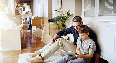 Buy stock photo Father, son and tablet, playing games and relax, break from unpacking and moving into new house. Man, boy and wireless tech with property, real estate and rest with video game online and bonding
