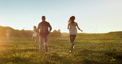 Buy stock photo Freedom, travel and family running on field with energy, love and fun bonding in nature together. Games, back and kids with parents in countryside for adventure, journey or vacation at sunset in park