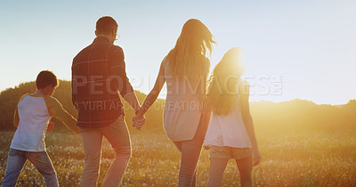 Buy stock photo Rearview shot of a family bonding together outdoors