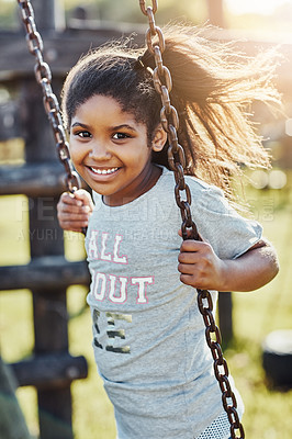 Buy stock photo African child, portrait and swing in park for outdoor fun with summer vacation, freedom and sunshine. Face smile, girl and happy on playground in nature for school holiday with relax, joy and youth