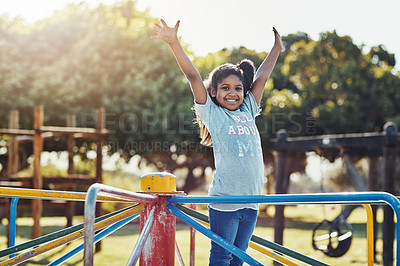 Buy stock photo Cropped portrait of an adorable little girl playing on a merry-go-round at the park