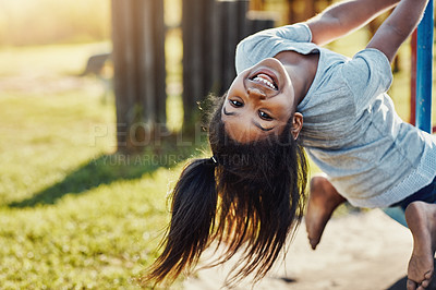 Buy stock photo Cropped portrait of an adorable little girl playing on a merry-go-round at the park