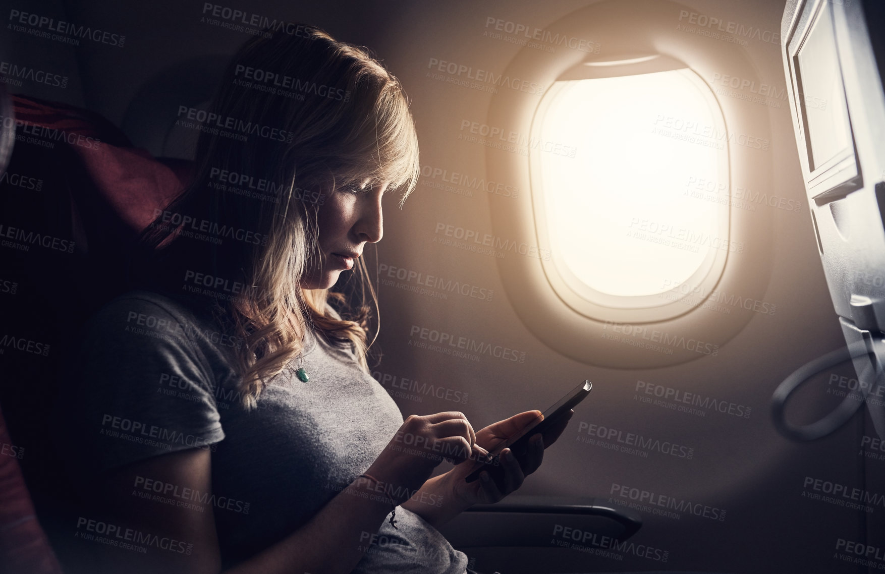 Buy stock photo Airplane, phone and woman by window for flight, international journey and global commute. Air transport, passenger and person on aeroplane on smartphone for holiday, travel website and vacation