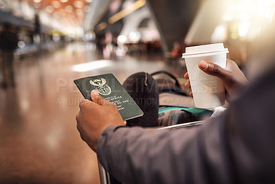 Buy stock photo POV shot of an unrecognizable man holding his passport and boarding pass while enjoying a coffee in the airport