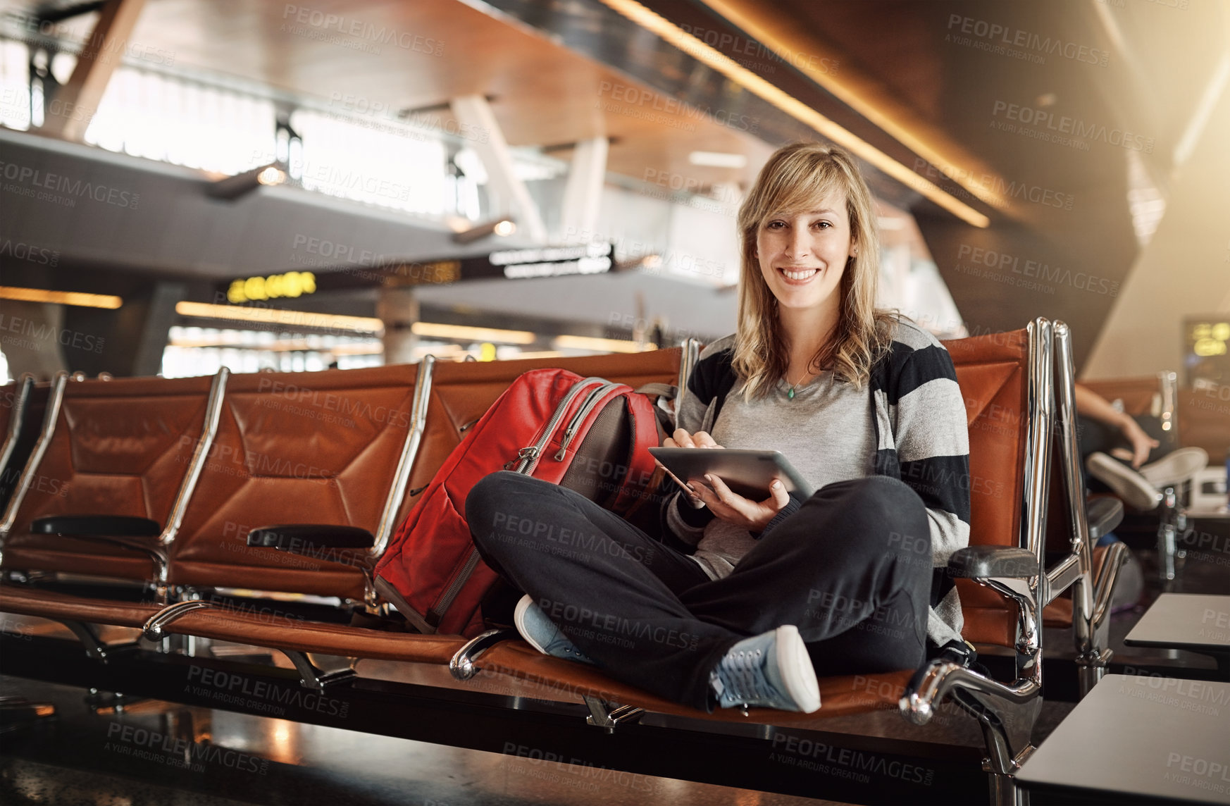 Buy stock photo Tablet, portrait and woman in lobby of airport, online and internet for movies, backpack and travel. Holiday, trip and vacation in Florida, waiting room and girl with connection for entertainment