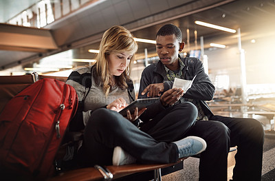 Buy stock photo Cropped shot of a young couple using a tablet in an airport