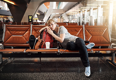 Buy stock photo Full length shot of an attractive young woman sleeping in an airport