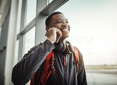 Buy stock photo Cropped shot of a handsome young man making a call while standing in an airport