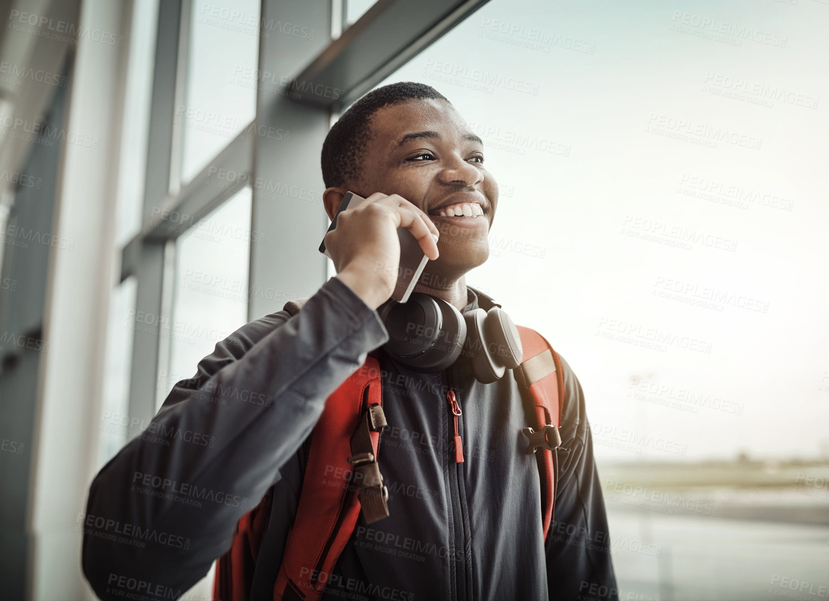 Buy stock photo Travel, phone call and black man in airport, smile and explanation to college of delay of airplane. Window, student and person with communication in waiting room, journey and trip to New York