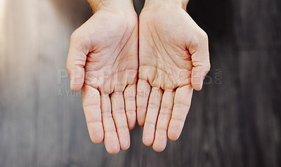 Buy stock photo High angle shot of an unrecognizable person's open hands shown against a dark background