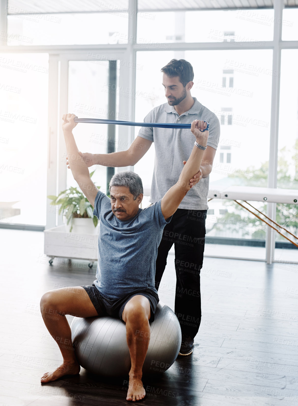 Buy stock photo Physiotherapy, medical and band with old man and doctor for training, rehabilitation and injury. Stretching, healing and healthcare with physiotherapist and patient for consulting, help and fitness