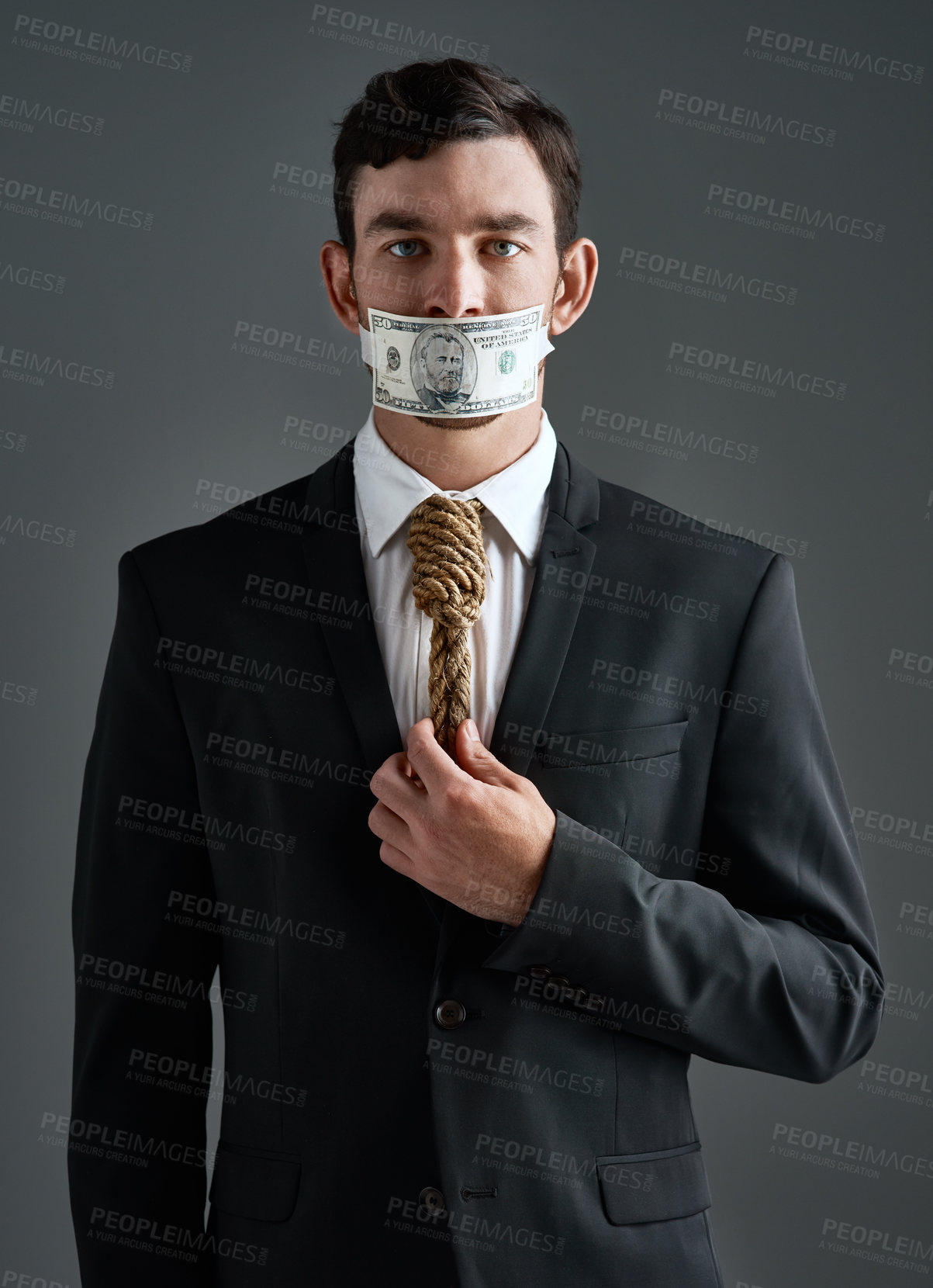 Buy stock photo Businessman, portrait and money gag with noose tie, finance debt and corporate economy pressure. Model, hanging and cost crisis for financial bondage, failure and execution on gray studio background