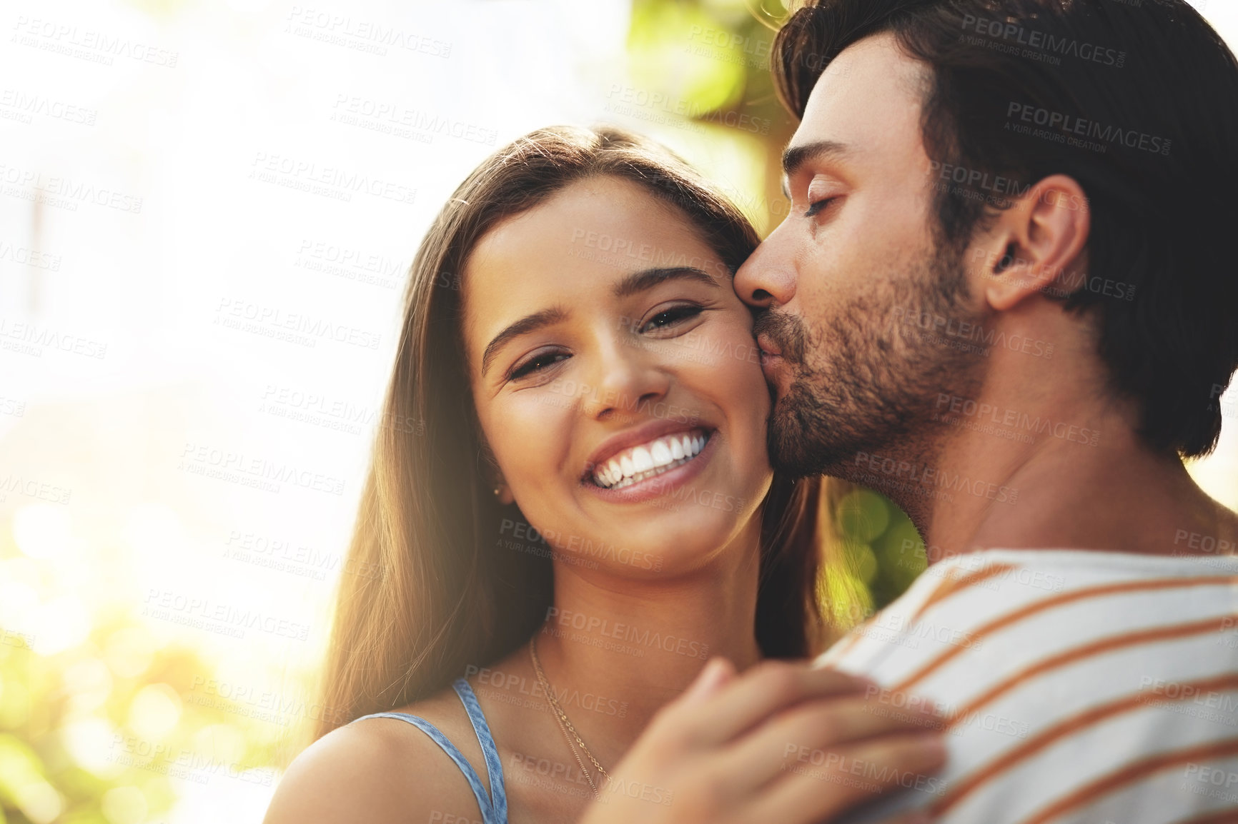 Buy stock photo Portrait, holiday or happy couple kiss in nature to date, smile or enjoy anniversary together for love. Outdoor, romantic or people in park for trust or bonding with care, support or special moment