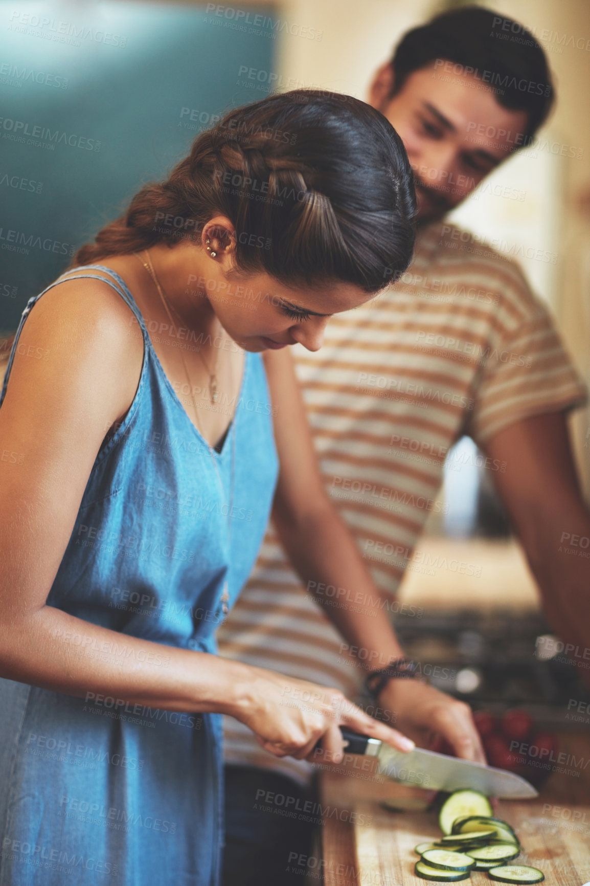 Buy stock photo Couple, cooking and cutting cucumber in kitchen for healthy food, diet and anniversary dinner in home. Man, woman and knife for vegetable slice with nutrition wellness, meal prep and love bonding